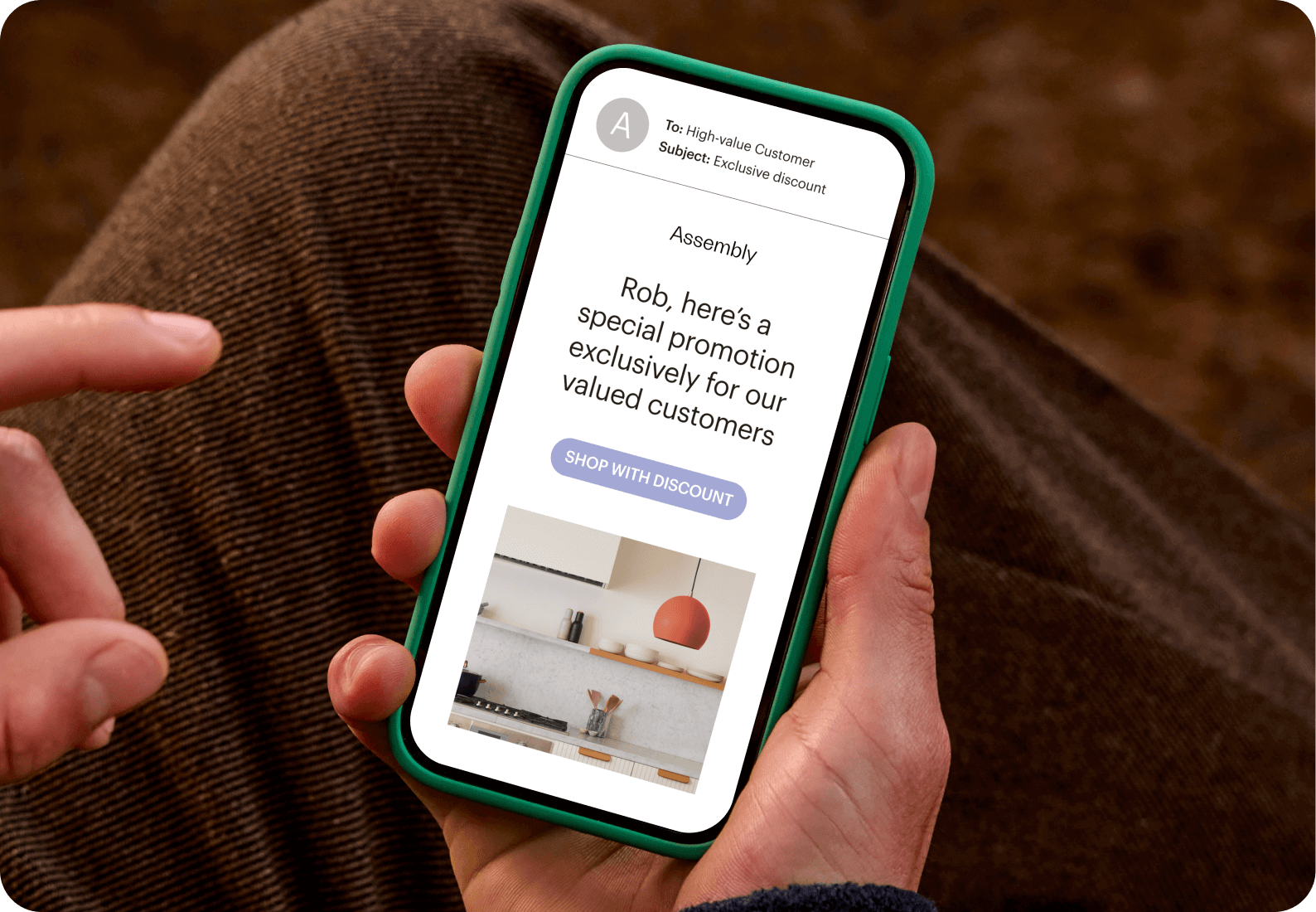Image of a person looking at a smartphone screen displaying an email from the fictitious brand Assembly. The visual demonstrates how users can personalize marketing campaigns with segments based on customer data.